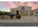 Stunning two-story home featuring a three-car garage and well-manicured desert landscaping at 4812 E Daley Ln, Phoenix, AZ 85054
