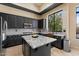 Beautiful kitchen featuring dark cabinets, granite countertops, and stainless steel appliances at 4812 E Daley Ln, Phoenix, AZ 85054
