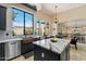 Modern kitchen features a stainless steel sink, a large island, and bright lighting fixtures at 4812 E Daley Ln, Phoenix, AZ 85054