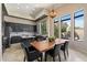 Modern kitchen with dark cabinets, granite countertops, island, and a breakfast nook at 4812 E Daley Ln, Phoenix, AZ 85054
