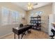 A well-lit office with a large window, a modern desk, and a bookshelf, perfect for working from home at 4812 E Daley Ln, Phoenix, AZ 85054