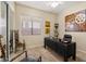 Well-appointed home office with a large desk, comfortable seating, and decorative art pieces at 4812 E Daley Ln, Phoenix, AZ 85054