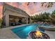 Gorgeous backyard oasis with a large pool, spa, covered patio, and a cozy fire pit at 4812 E Daley Ln, Phoenix, AZ 85054