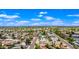 Great aerial view of a home in a well-established neighborhood with mature trees, sparkling pools, and a blue sky overhead at 5004 W Kaler Dr, Glendale, AZ 85301