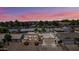 Sunset aerial view of a beautiful, two-story home with lush landscaping, an attached two-car garage, and a desert landscape at 5004 W Kaler Dr, Glendale, AZ 85301