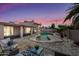 A beautiful outdoor space featuring a uniquely shaped swimming pool and beautiful landscaping at 5004 W Kaler Dr, Glendale, AZ 85301