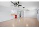 Spacious basement with tile flooring, a wet bar area, and three ceiling fans providing ample lighting at 5004 W Kaler Dr, Glendale, AZ 85301