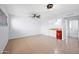 Spacious basement with tile flooring, a wet bar area, and three ceiling fans providing ample lighting at 5004 W Kaler Dr, Glendale, AZ 85301