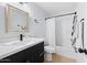 Modern bathroom featuring a sleek vanity with white countertop and a shower-tub combo with white shower curtain at 5004 W Kaler Dr, Glendale, AZ 85301