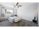 Bright bedroom with a ceiling fan, large window, and a cozy bed, creating a relaxing and inviting atmosphere at 5004 W Kaler Dr, Glendale, AZ 85301