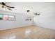 Empty room with tile flooring, ceiling fans and large windows providing natural light at 5004 W Kaler Dr, Glendale, AZ 85301