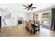 Bright dining area with a modern ceiling fan, sliding glass doors, and views of the outdoor area at 5004 W Kaler Dr, Glendale, AZ 85301