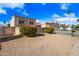 Charming exterior featuring a desert landscape, custom iron gate, and a two-car garage at 5004 W Kaler Dr, Glendale, AZ 85301