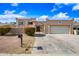 Exterior view featuring decorative front gate, desert landscaping, and spacious driveway at 5004 W Kaler Dr, Glendale, AZ 85301