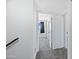Upstairs hallway with carpet, white doors, and a view into a bedroom, creating a cohesive and clean aesthetic at 5004 W Kaler Dr, Glendale, AZ 85301