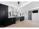 Bright kitchen featuring stainless steel appliances, dark cabinets, and a tiled floor at 5004 W Kaler Dr, Glendale, AZ 85301