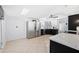 Well-lit kitchen featuring stainless steel appliances, a bright skylight, and ample counter space at 5004 W Kaler Dr, Glendale, AZ 85301