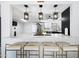 Modern kitchen boasts quartz countertops, counter seating, and stainless appliances at 5004 W Kaler Dr, Glendale, AZ 85301