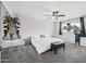 Serene bedroom with a ceiling fan, large window, and a comfortable bed, creating a peaceful retreat at 5004 W Kaler Dr, Glendale, AZ 85301