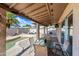 Covered patio with a table and seating with a view of the pool and backyard at 5004 W Kaler Dr, Glendale, AZ 85301