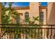 Balcony view of lush greenery and neighboring building with architectural details at 5015 E Cheyenne Dr # 31, Phoenix, AZ 85044