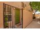 Gated entry to a condo with a green door, window, and small plant creating an inviting and private entrance at 5015 E Cheyenne Dr # 31, Phoenix, AZ 85044