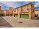 View of garages with green doors and building with terracotta tile roofs at 5015 E Cheyenne Dr # 31, Phoenix, AZ 85044