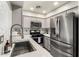 Modern kitchen with stainless steel appliances, gray cabinetry, and ample countertop space, perfect for cooking at 5015 E Cheyenne Dr # 31, Phoenix, AZ 85044