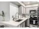 Well-lit kitchen featuring white countertops, mosaic backsplash, and modern appliances, creating a clean culinary space at 5015 E Cheyenne Dr # 31, Phoenix, AZ 85044
