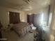 Bedroom with tile flooring featuring a ceiling fan and window with sunlight streaming in at 520 W Mcneil St, Phoenix, AZ 85041