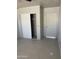 Bedroom with tile floors, closet, and a door leading to the hallway at 520 W Mcneil St, Phoenix, AZ 85041