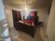 This bedroom features tile flooring, a ceiling fan, and a large window with red and black curtains at 520 W Mcneil St, Phoenix, AZ 85041