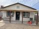 Exterior view of the home featuring a covered porch, fresh paint and new windows at 520 W Mcneil St, Phoenix, AZ 85041