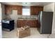 Spacious kitchen featuring stainless steel appliances, wood cabinets, and granite countertops at 520 W Mcneil St, Phoenix, AZ 85041