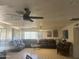 Spacious living room featuring tile floors, multiple seating arrangements, and a large ceiling fan at 520 W Mcneil St, Phoenix, AZ 85041