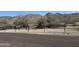 Scenic view of mountains behind a gravel trail and a metal rail, promoting outdoor activities at 520 W Mcneil St, Phoenix, AZ 85041
