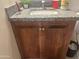 Bathroom vanity with granite countertop, wooden cabinets, and a modern sink at 520 W Mcneil St, Phoenix, AZ 85041