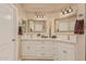Bright bathroom with double sinks, framed mirrors and a full set of cabinets for storage at 5511 N 128Th Dr, Litchfield Park, AZ 85340