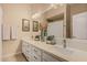 Bathroom with a double vanity, a large mirror and a tile floor at 5511 N 128Th Dr, Litchfield Park, AZ 85340