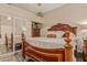 Bedroom featuring a wooden bed frame, dark floors, and a mirrored closet at 5511 N 128Th Dr, Litchfield Park, AZ 85340