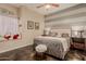 Bedroom with a plush bed, a window seat, modern floors, and gray and white striped walls at 5511 N 128Th Dr, Litchfield Park, AZ 85340