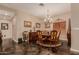 Elegant dining room featuring a chandelier, dark accents, and space for entertaining guests at 5511 N 128Th Dr, Litchfield Park, AZ 85340