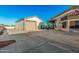 Spacious driveway leading to detached garage and house with large porte-cochere at 5511 N 128Th Dr, Litchfield Park, AZ 85340