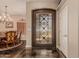 Welcoming foyer featuring a decorative glass front door, adjacent to a dining room space at 5511 N 128Th Dr, Litchfield Park, AZ 85340