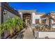 Inviting front entrance with an outdoor seating area, tiled roof, and decorative accents at 5511 N 128Th Dr, Litchfield Park, AZ 85340
