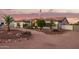 Attractive single story desert home at sunset featuring a desert landscaped front yard at 5511 N 128Th Dr, Litchfield Park, AZ 85340