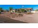 Front view of a well-kept property featuring beautiful landscaping with stone features and a desert-style yard at 5511 N 128Th Dr, Litchfield Park, AZ 85340