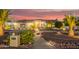 Inviting desert home featuring low maintenance landscaping, walkway, and front entryway at sunset at 5511 N 128Th Dr, Litchfield Park, AZ 85340