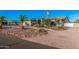 Attractive single story desert home with low maintenance desert landscaping, mature palms, and front driveway at 5511 N 128Th Dr, Litchfield Park, AZ 85340