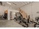 This garage space is equipped with gym and work-out equipment at 5511 N 128Th Dr, Litchfield Park, AZ 85340